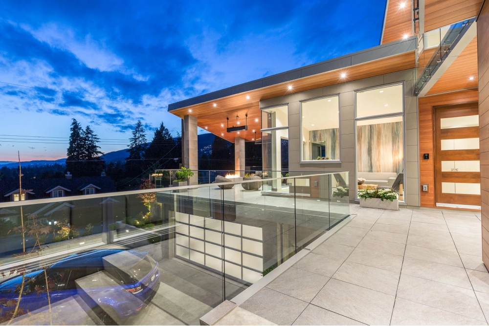 Luxury home exterior at dusk with outdoor patio